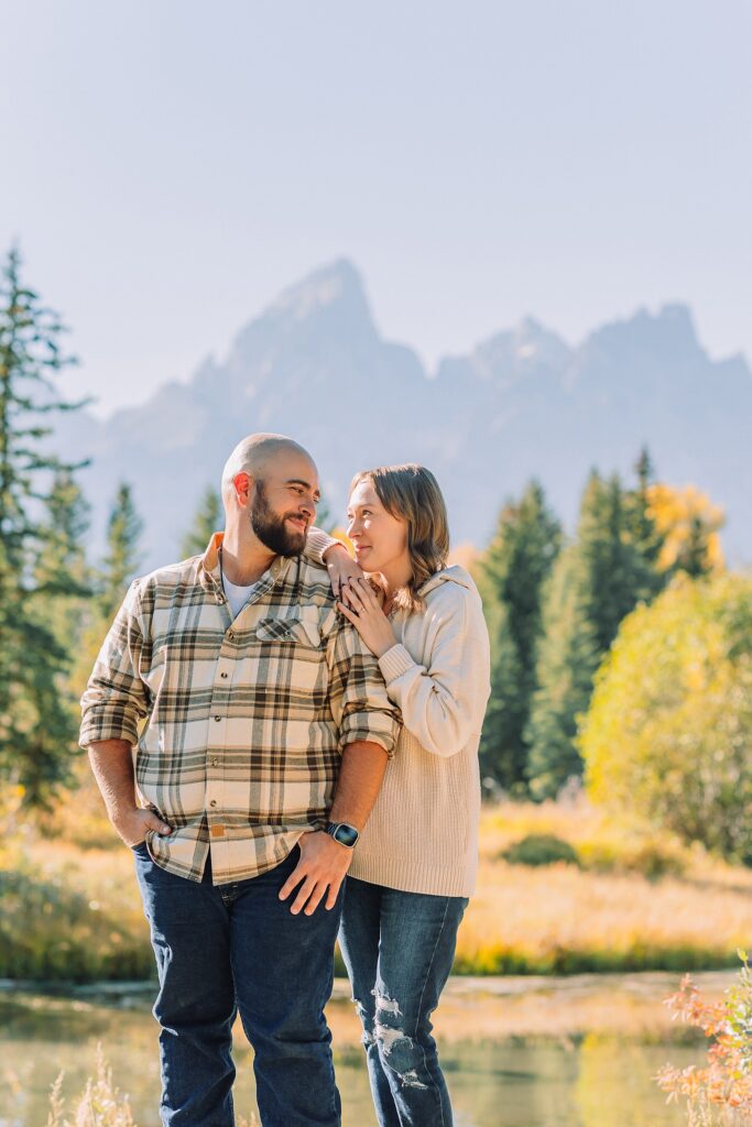 Buckrail fence rustic engagement portraits September Teton engagement photography golden hour Candid mountain couple photos engagement session Jackson Hole Photographer