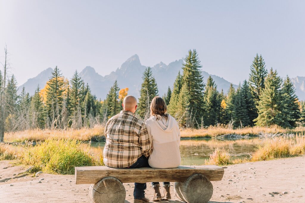 Jackson Hole Photographer Casual mountain engagement photos with jeans Fall engagement session Grand Tetons Wyoming Cream sweater engagement photos mountain backdrop
