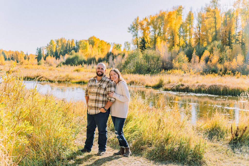 Jackson Hole Photographer Casual mountain engagement photos with jeans Fall engagement session Grand Tetons Wyoming Cream sweater engagement photos mountain backdrop