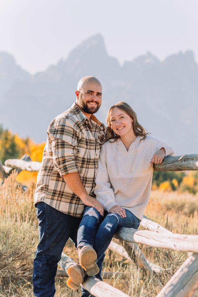 Casual mountain engagement photos with jeans Fall engagement session Grand Tetons Wyoming Cream sweater engagement photos mountain backdrop September Teton engagement photography golden hour Candid mountain couple photos engagement session