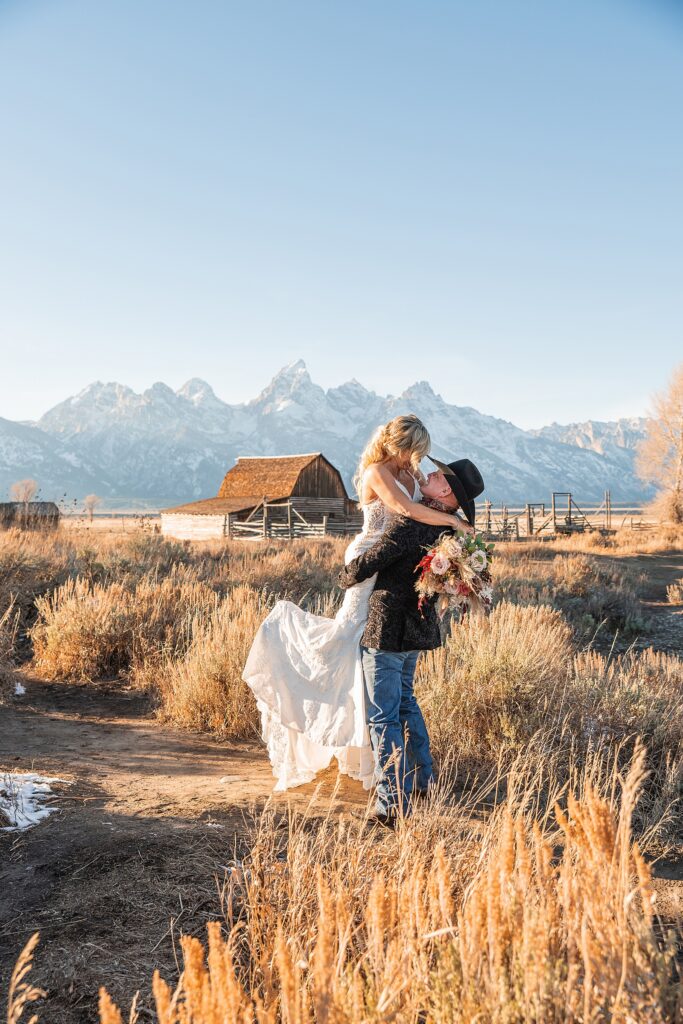 Mormon Row wedding portraits golden hour Rustic mountain wedding with Teton backdrop Cowboy themed groom style mountain wedding Vintage barn wedding photos Jackson Hole
