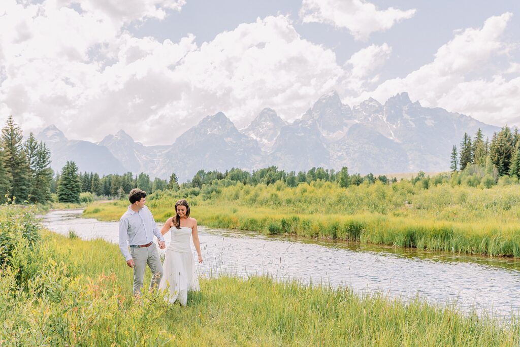 mountain engagement session with river views Grand Tetons white dress engagement photos in nature shaded forest engagement photos summer session romantic nature engagement session July Wyoming