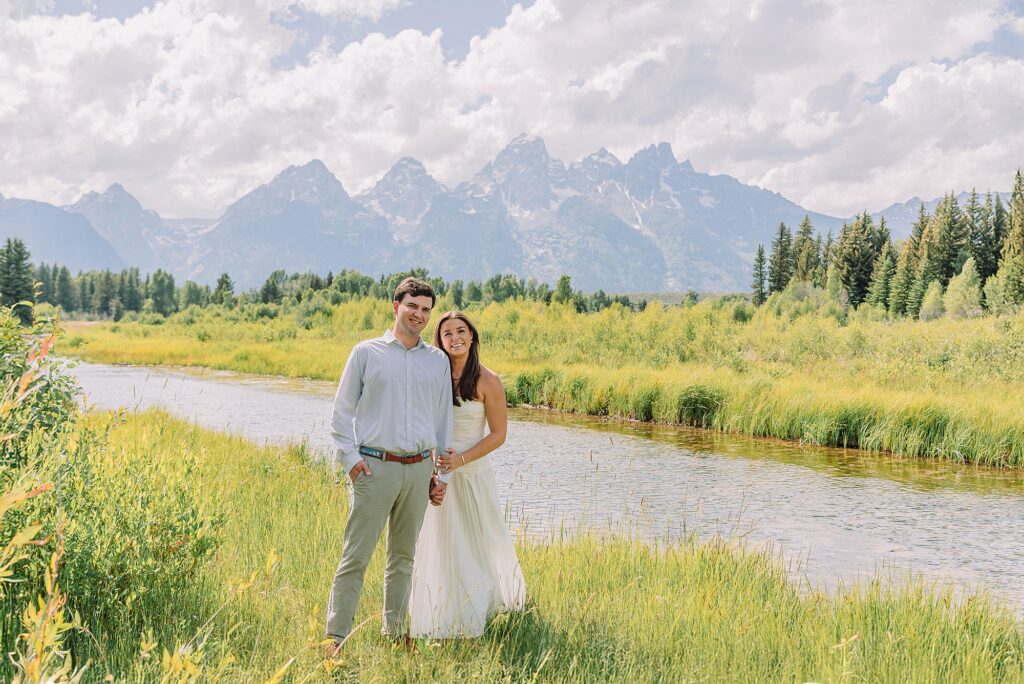 mountain engagement session with river views Grand Tetons white dress engagement photos in nature shaded forest engagement photos summer session romantic nature engagement session July Wyoming