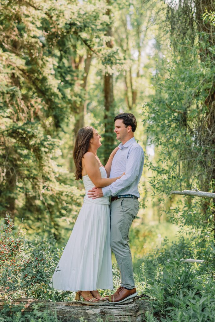 summer engagement photos at Schwabacher Landing Wyoming mountain engagement session with river views Grand Tetons white dress engagement photos in nature shaded forest engagement photos summer session romantic nature engagement session July Wyoming