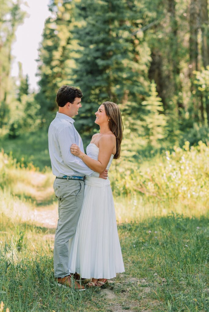summer engagement photos at Schwabacher Landing Wyoming mountain engagement session with river views Grand Tetons white dress engagement photos in nature shaded forest engagement photos summer session romantic nature engagement session July Wyoming