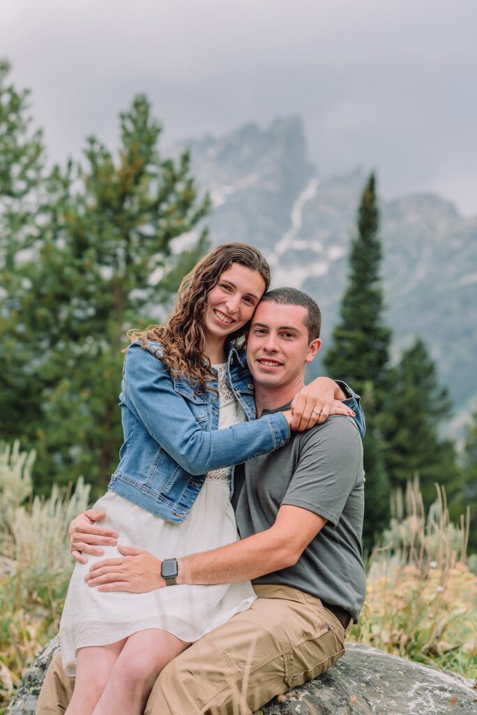 outdoor family photographer Teton mountains Wyoming Jenny Lake engagement photos windy conditions Mountain View Turnout couple portraits Grand Tetons Teton Glacier Turnout western family photos Grand Teton vacation photographer coordinating family outfits without matching