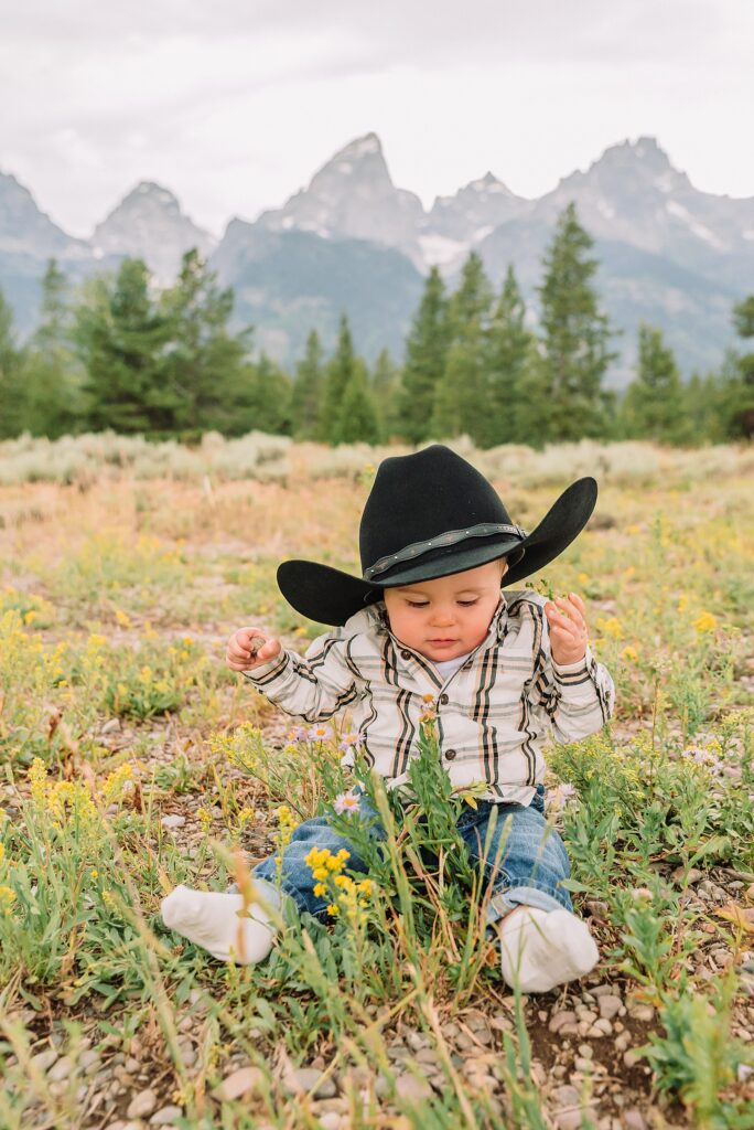 outdoor family photos with baby Grand Tetons purple western shirt family portraits Wyoming cream plaid toddler outdoor photos mountains flexible outdoor photography session inclement weather Jackson Hole Photographer Grand Teton National Park family photographer