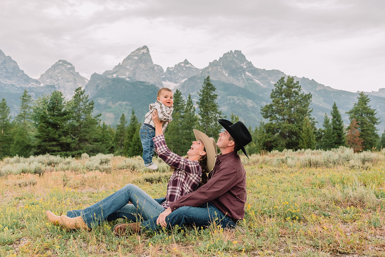 outdoor family photos with baby Grand Tetons purple western shirt family portraits Wyoming cream plaid toddler outdoor photos mountains flexible outdoor photography session inclement weather Jackson Hole Photographer Grand Teton National Park family photographer