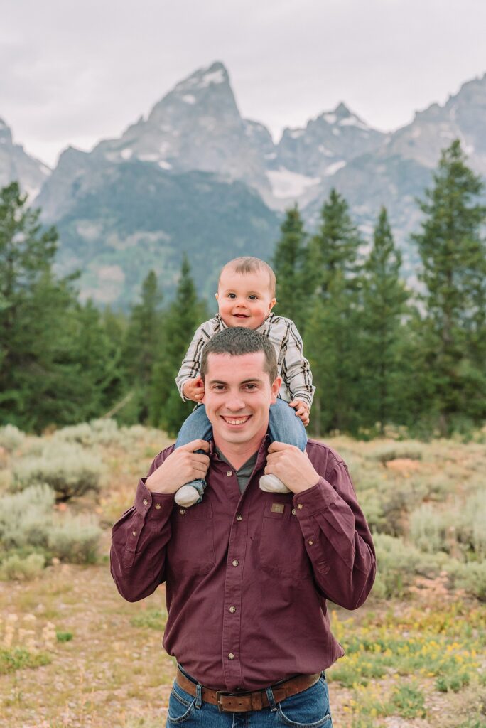 outdoor family photos with baby Grand Tetons purple western shirt family portraits Wyoming cream plaid toddler outdoor photos mountains flexible outdoor photography session inclement weather Jackson Hole Photographer Grand Teton National Park family photographer