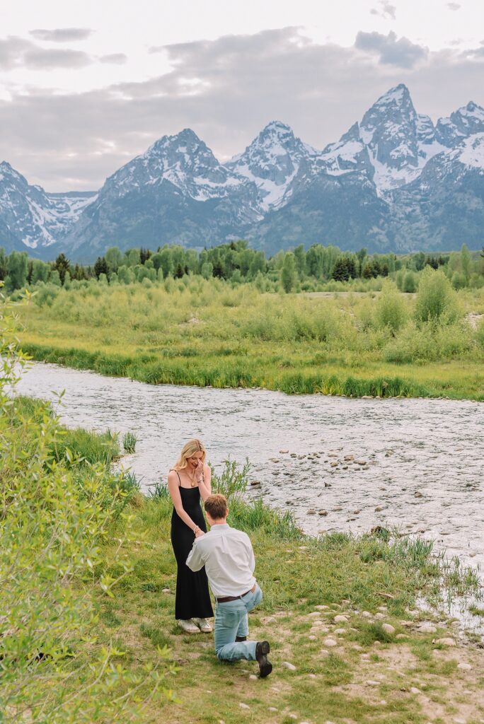 Grand Teton proposal photographer Schwabacher Landing surprise riverside proposal Grand Teton National Park early summer engagement photos Jackson Hole Wyoming mountain backdrop proposal photography Grand Tetons Schwabacher Landing proposal session June