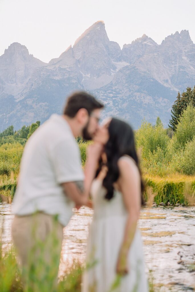 Schwabacher Landing engagement photos Grand Teton National Park white corset dress mountain engagement session Wyoming sunset engagement photos Teton mountain range backdrop couple wearing white outfits Grand Teton engagement shoot Jackson Hole Engagement Photographer