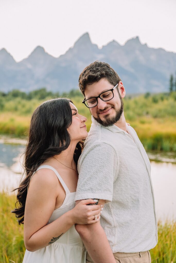 Schwabacher Landing engagement photos Grand Teton National Park white corset dress mountain engagement session Wyoming sunset engagement photos Teton mountain range backdrop couple wearing white outfits Grand Teton engagement shoot Jackson Hole Engagement Photographer