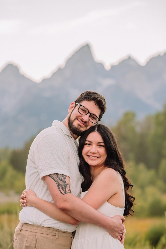Schwabacher Landing engagement photos Grand Teton National Park white corset dress mountain engagement session Wyoming sunset engagement photos Teton mountain range backdrop couple wearing white outfits Grand Teton engagement shoot Jackson Hole Engagement Photographer