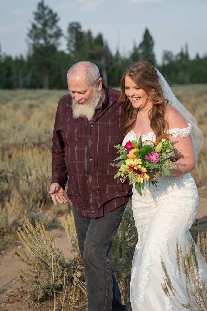 Teton Mountains elopement photography intimate ceremony Cathedral View Turnout wedding photographer Wyoming bride with white cowgirl boots mountain wedding intimate family elopement Teton National Park