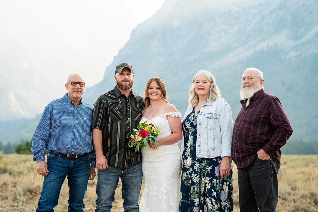 Teton Mountains elopement photography intimate ceremony Cathedral View Turnout wedding photographer Wyoming bride with white cowgirl boots mountain wedding intimate family elopement Teton National Park