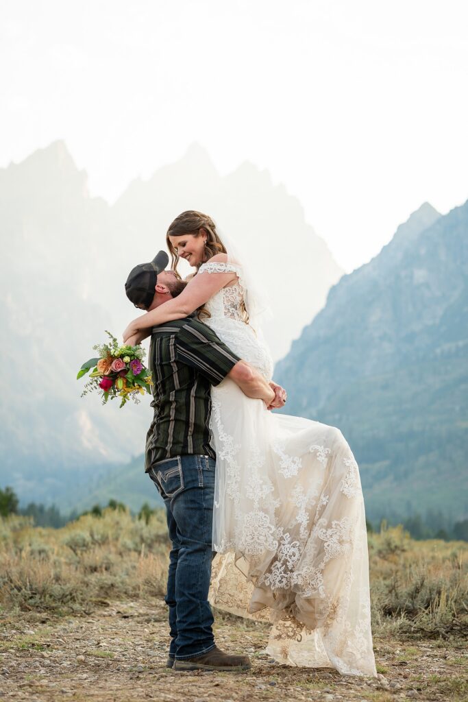 Teton Mountains elopement photography intimate ceremony Cathedral View Turnout wedding photographer Wyoming bride with white cowgirl boots mountain wedding intimate family elopement Teton National Park