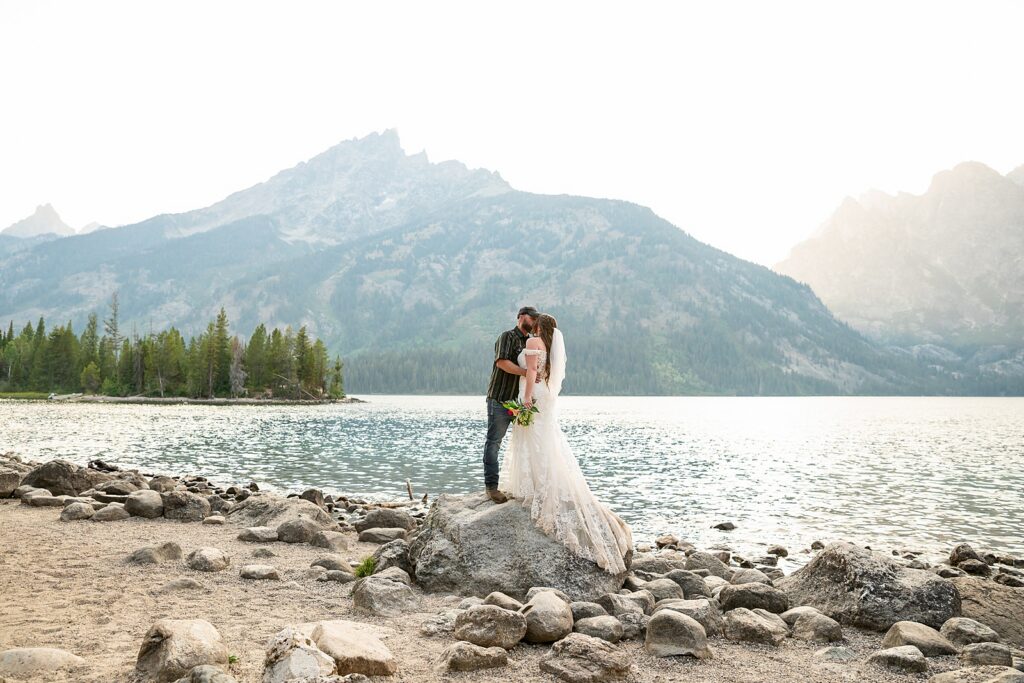 Jenny Lake sunset elopement portraits lace wedding gown Teton Mountains elopement Lakeshore wedding photos in Jackson Hole