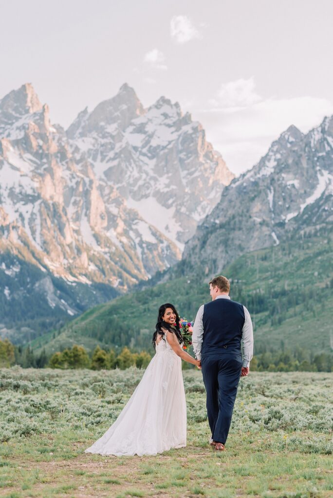 Cathedral View Turnout couple photos Grand Tetons candid elopement photography Teton Range backdrop playful elopement photos Grand Teton National Park intimate couple portraits Jackson Hole Wyoming outdoor wedding ceremony mountain backdrop photography