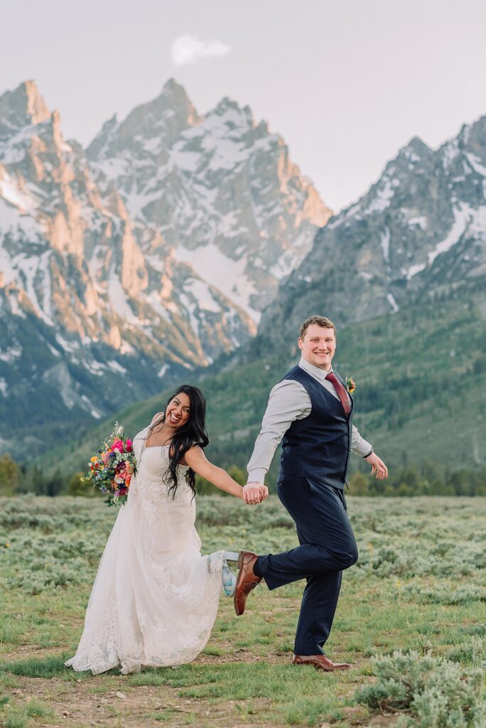 Cathedral View Turnout couple photos Grand Tetons candid elopement photography Teton Range backdrop playful elopement photos Grand Teton National Park intimate couple portraits Jackson Hole Wyoming outdoor wedding ceremony mountain backdrop photography