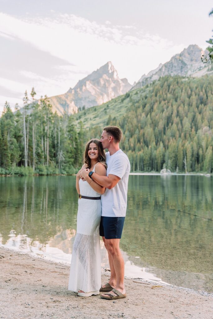 Tetons engagement photos at String Lake Grand Teton National Park engagement session String Lake engagement photography Wyoming mountain engagement photos wooden bridge casual mountain engagement session ideas dramatic Teton peaks engagement portraits playful couple poses mountain backdrop String Lake trailhead engagement pictures