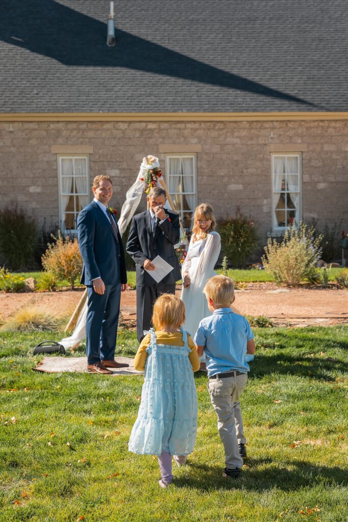 backyard elopement to wedding celebration handmade wedding arch ceremony photography Utah Wedding Photographer small town Utah wedding celebration