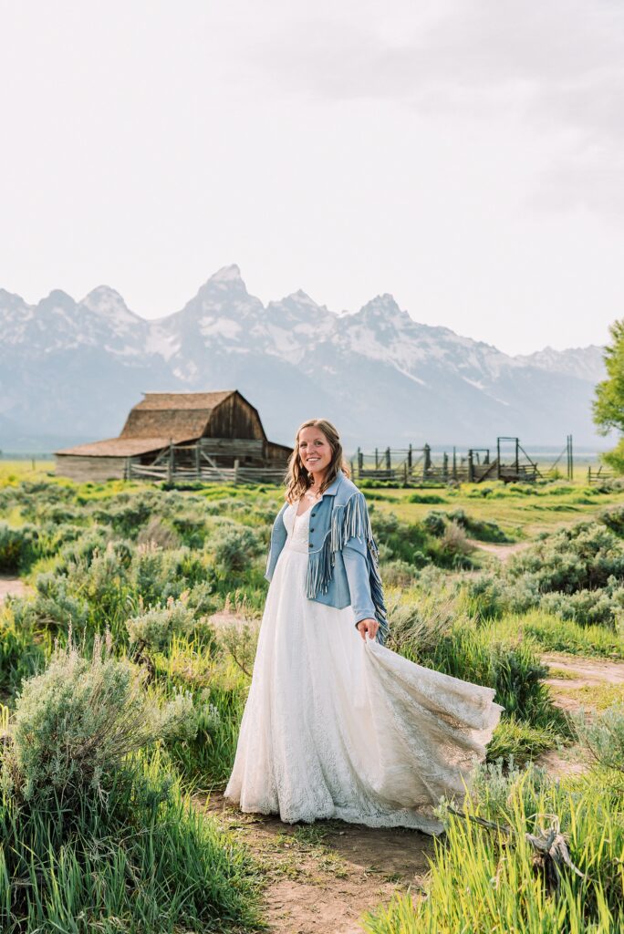 Jackson Hole Wyoming wedding photography Jackson Hole wedding photography Mormon Row portraits Bride fringed jean jacket Western wedding style Mormon Row Rustic Barn Wedding