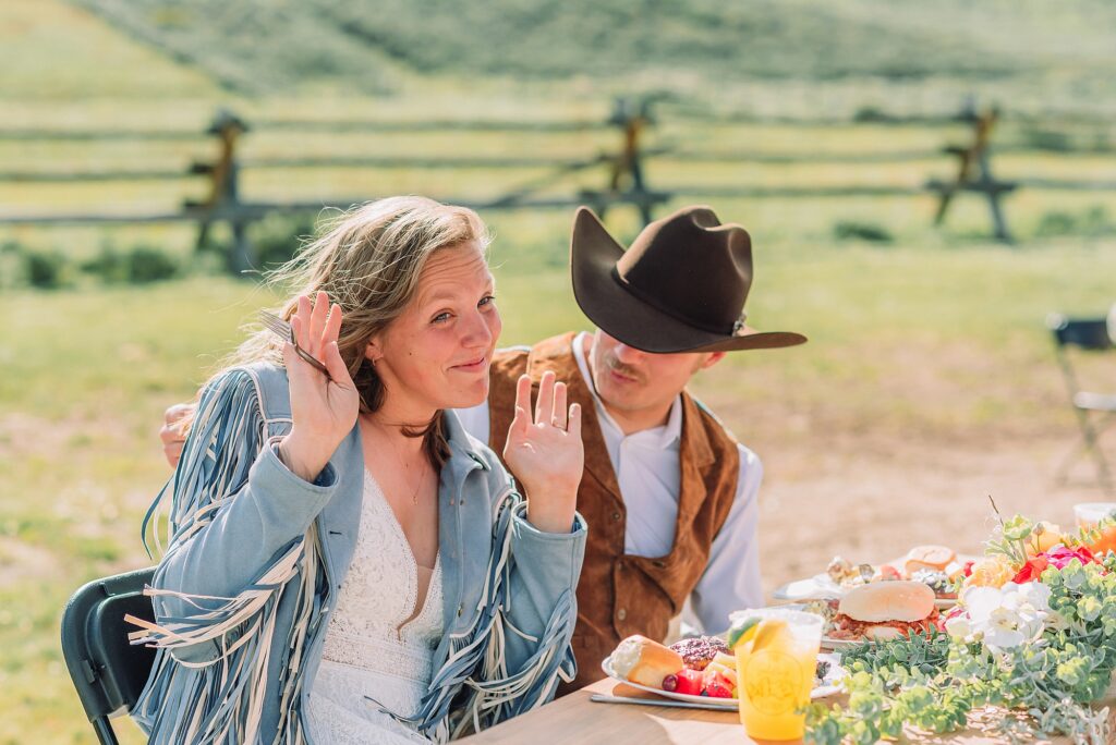 Rustic Wyoming outdoor wedding reception dance floor Faith-based knot tying wedding ceremony Wyoming Candid hilarious cake cutting wedding photos Two-day Wyoming wedding ceremony and reception photography destination Wyoming wedding photography