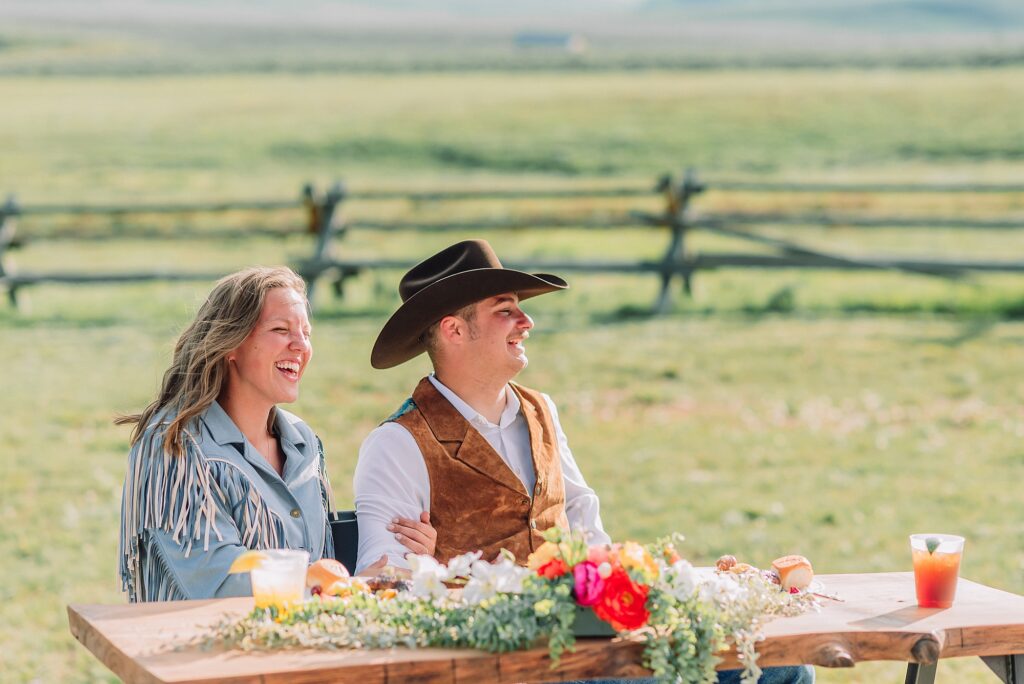 Rustic Wyoming outdoor wedding reception dance floor Faith-based knot tying wedding ceremony Wyoming Candid hilarious cake cutting wedding photos Two-day Wyoming wedding ceremony and reception photography destination Wyoming wedding photography