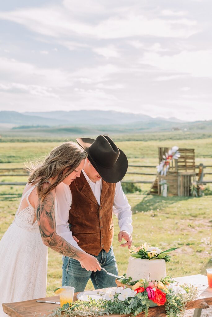 Rustic Wyoming outdoor wedding reception dance floor Faith-based knot tying wedding ceremony Wyoming Candid hilarious cake cutting wedding photos Two-day Wyoming wedding ceremony and reception photography destination Wyoming wedding photography