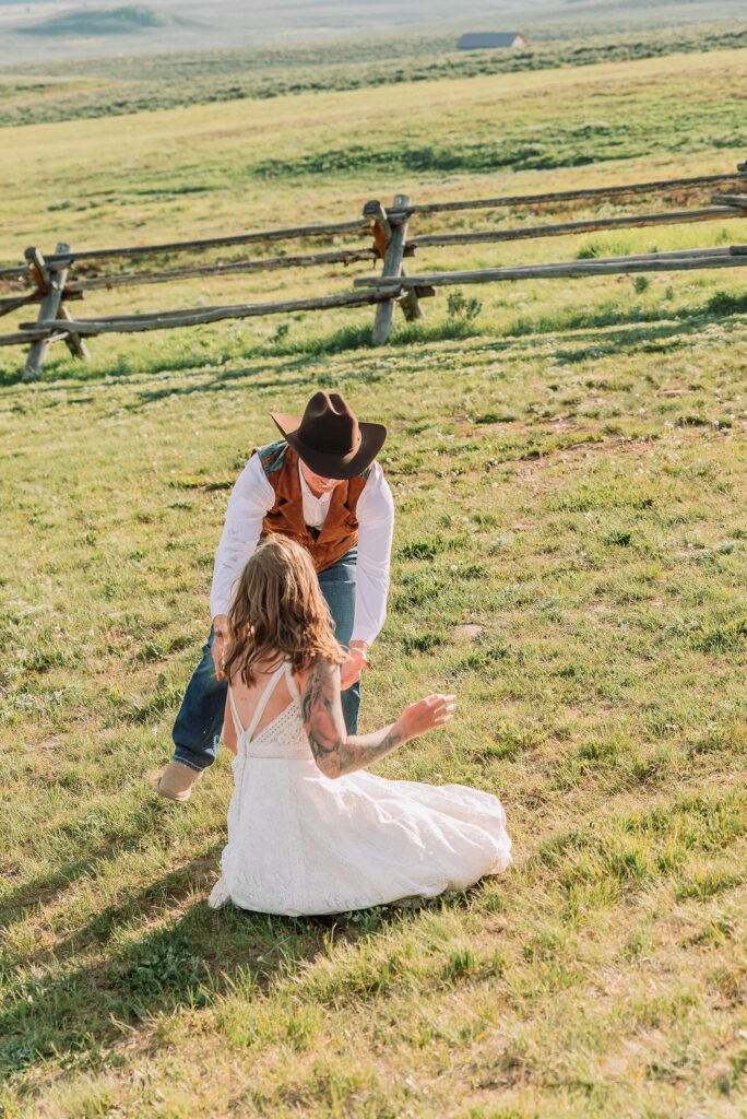 Rustic Wyoming outdoor wedding reception dance floor Faith-based knot tying wedding ceremony Wyoming Candid hilarious cake cutting wedding photos Two-day Wyoming wedding ceremony and reception photography destination Wyoming wedding photography