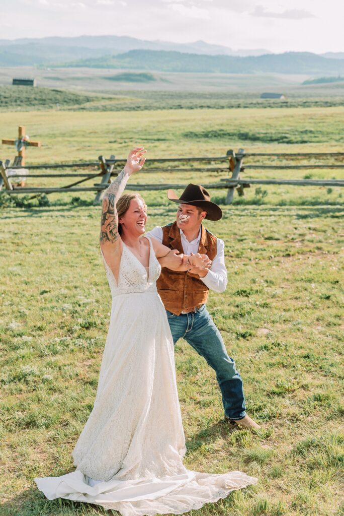 Rustic Wyoming outdoor wedding reception dance floor Faith-based knot tying wedding ceremony Wyoming Candid hilarious cake cutting wedding photos Two-day Wyoming wedding ceremony and reception photography destination Wyoming wedding photography