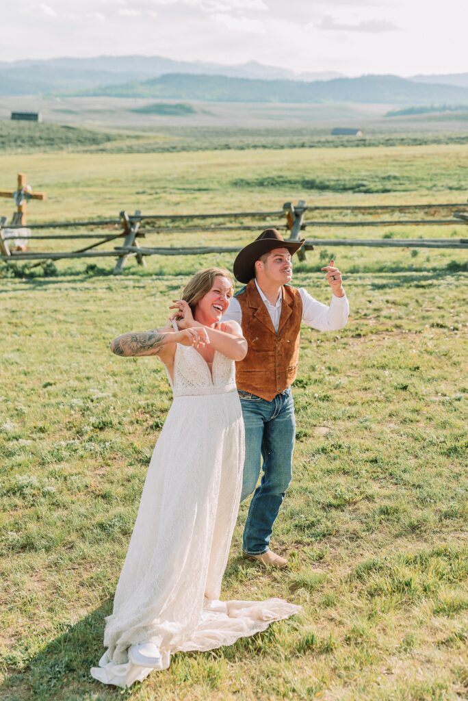 Rustic Wyoming outdoor wedding reception dance floor Faith-based knot tying wedding ceremony Wyoming Candid hilarious cake cutting wedding photos Two-day Wyoming wedding ceremony and reception photography destination Wyoming wedding photography