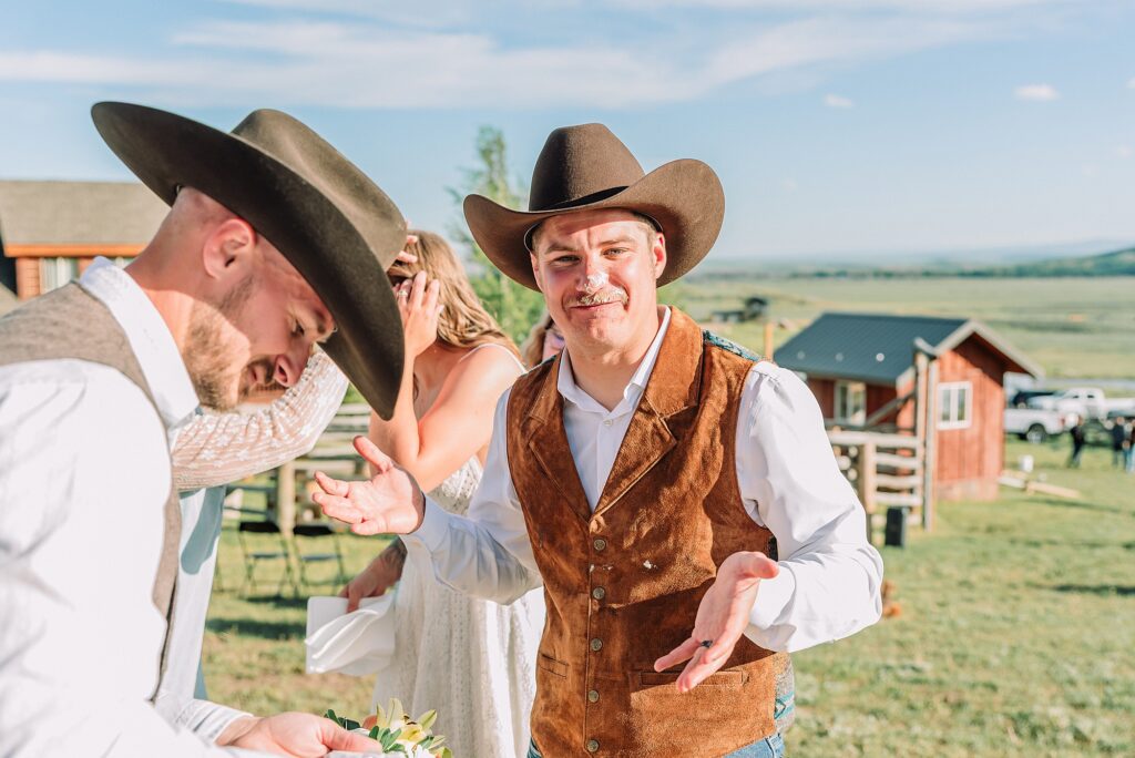 Rustic Wyoming outdoor wedding reception dance floor Faith-based knot tying wedding ceremony Wyoming Candid hilarious cake cutting wedding photos Two-day Wyoming wedding ceremony and reception photography destination Wyoming wedding photography