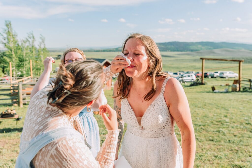 Rustic Wyoming outdoor wedding reception dance floor Faith-based knot tying wedding ceremony Wyoming Candid hilarious cake cutting wedding photos Two-day Wyoming wedding ceremony and reception photography destination Wyoming wedding photography
